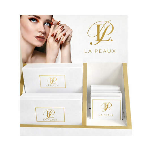 LA PEAUX white gift box menu stand with product packaging with a woman's face on a white background
